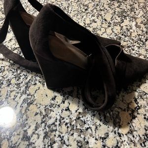 Brown high heels wedge with ties around the ankles.